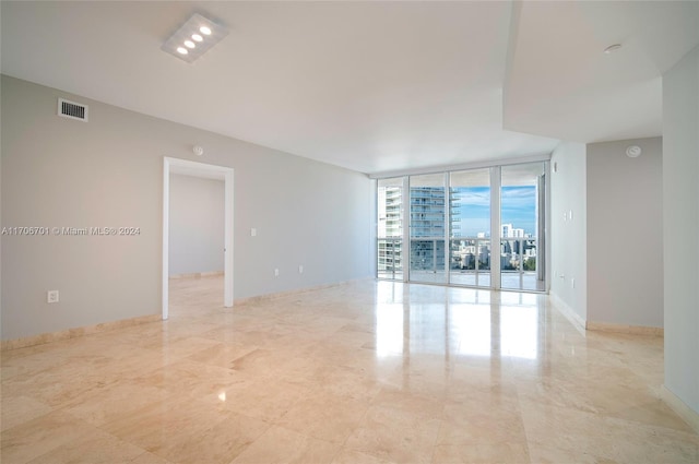 400 Alton Rd Unit 2309, Miami Beach, FL 33139 - spare room featuring floor to ceiling windows and baseboards