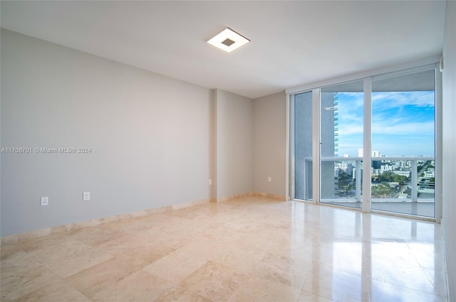 spare room featuring a wall of windows