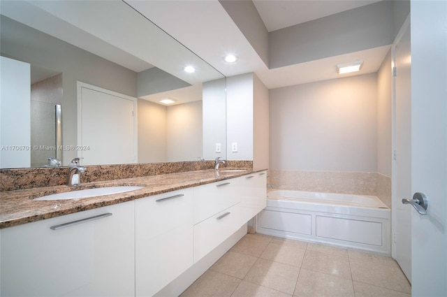 bathroom featuring tile patterned floors, a bathtub, and vanity