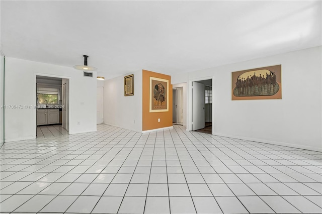 empty room featuring sink and light tile patterned floors