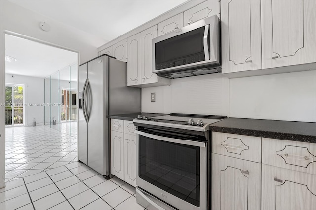 kitchen featuring light tile patterned floors and appliances with stainless steel finishes