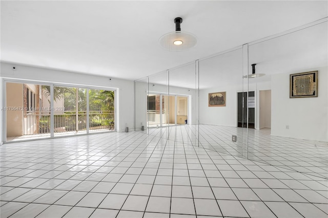 unfurnished living room with light tile patterned floors