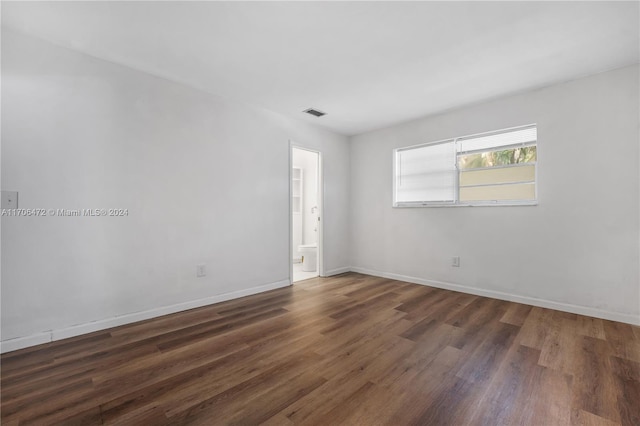 unfurnished room featuring dark hardwood / wood-style floors