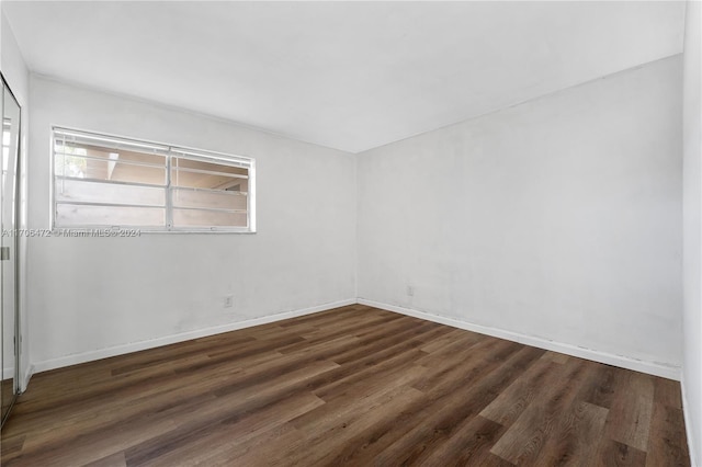 empty room with dark wood-type flooring