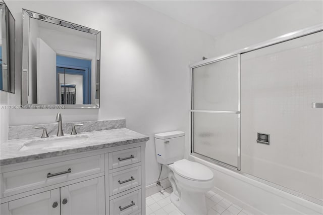 full bathroom featuring tile patterned floors, vanity, toilet, and enclosed tub / shower combo