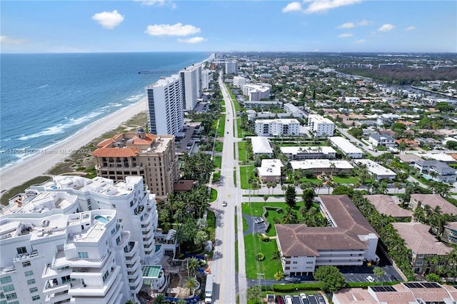 aerial view with a water view and a beach view