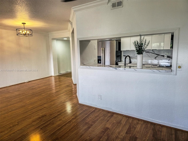 kitchen featuring white cabinetry, dark wood-type flooring, stainless steel fridge with ice dispenser, a notable chandelier, and decorative light fixtures