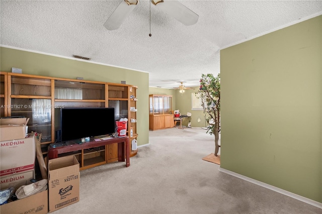 living room with crown molding, carpet flooring, a textured ceiling, and ceiling fan