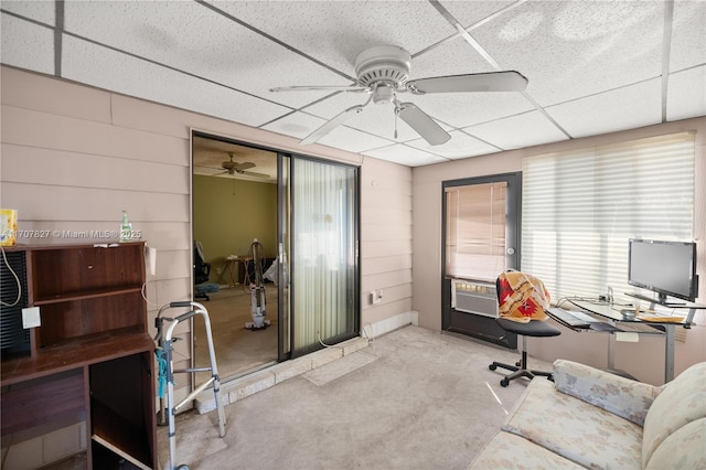 carpeted office with a paneled ceiling, ceiling fan, and cooling unit