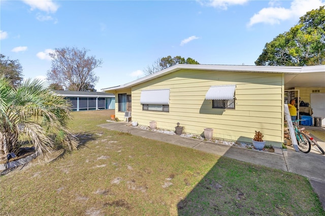 rear view of property with a lawn