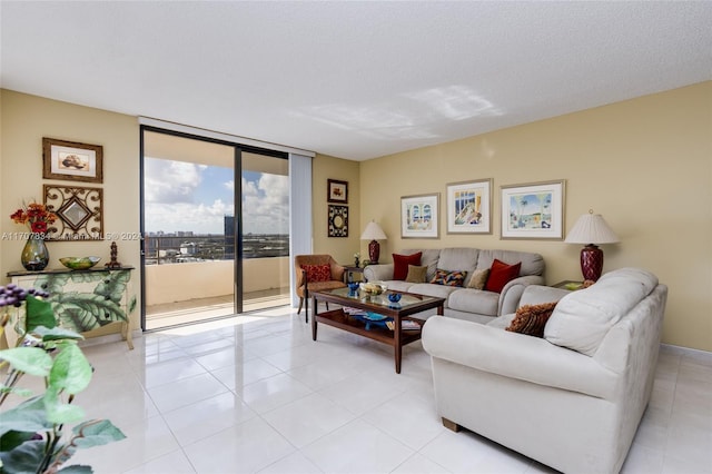 living room featuring a textured ceiling and a wall of windows