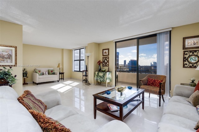 2500 Parkview Dr Unit 2315, Hallandale Beach, FL 33009 - living room with a textured ceiling, light tile patterned flooring, a city view, and floor to ceiling windows