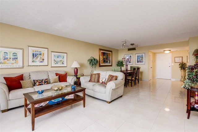 living room featuring light tile patterned floors and a textured ceiling