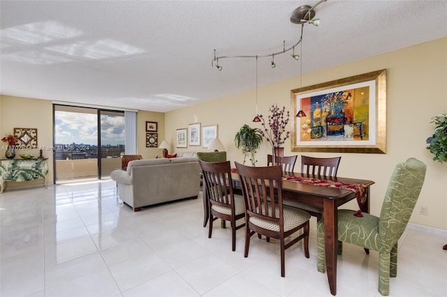 dining area featuring expansive windows and a textured ceiling