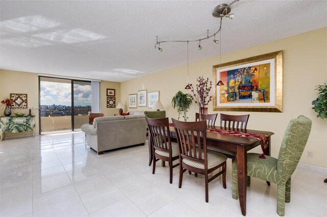 2500 Parkview Dr Unit 2315, Hallandale Beach, FL 33009 - dining room featuring a textured ceiling, floor to ceiling windows, and light tile patterned floors