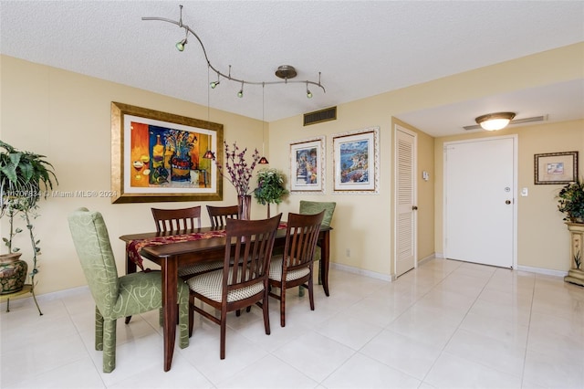 dining space with a textured ceiling