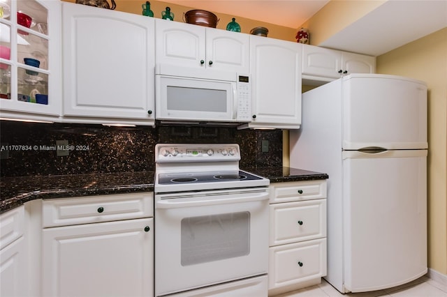 kitchen featuring decorative backsplash, white cabinetry, light tile patterned flooring, and white appliances