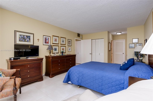 2500 Parkview Dr Unit 2315, Hallandale Beach, FL 33009 - bedroom featuring light tile patterned floors, a closet, and a textured ceiling