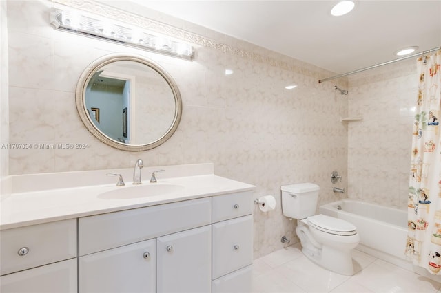 full bathroom featuring tile patterned floors, shower / bath combination with curtain, toilet, vanity, and tile walls