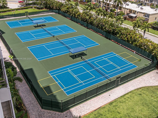 view of tennis court with basketball hoop