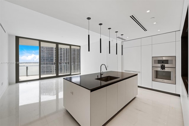 300 Biscayne Blvd Way Unit 3406, Miami, FL 33131 - kitchen featuring modern cabinets, a sink, white cabinets, dark countertops, and floor to ceiling windows