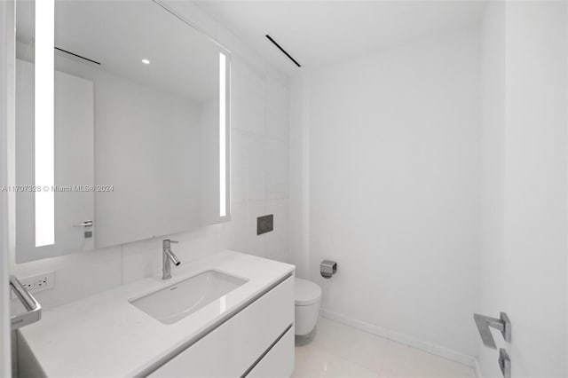 bathroom featuring tile patterned floors, vanity, and toilet