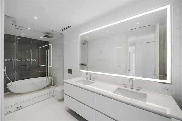 full bathroom featuring tile patterned flooring, vanity, separate shower and tub, and toilet