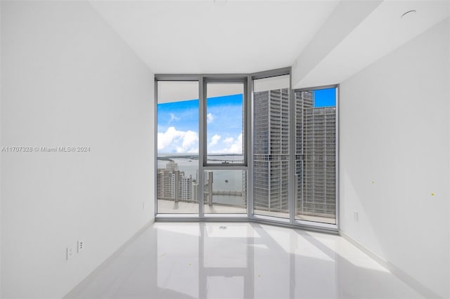 unfurnished room featuring floor to ceiling windows