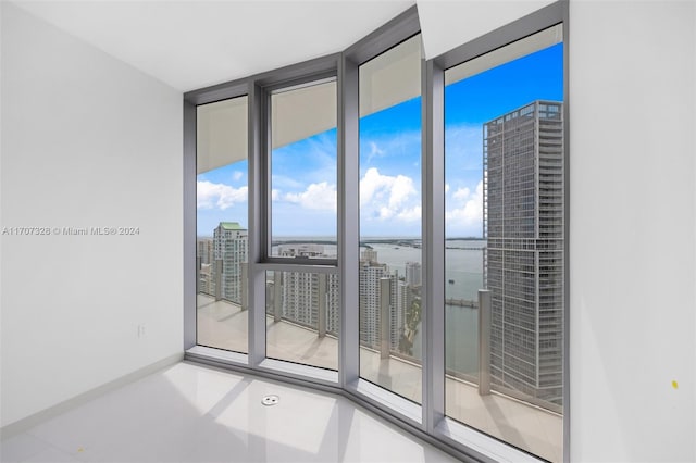 unfurnished room with expansive windows