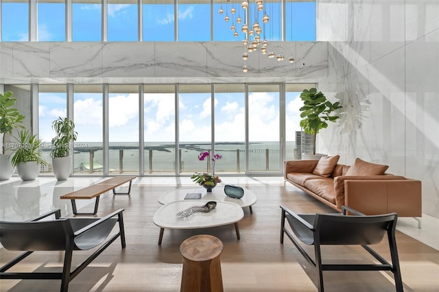 sunroom / solarium featuring a water view and a wealth of natural light