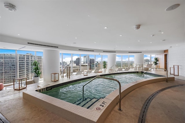 view of swimming pool with an indoor hot tub