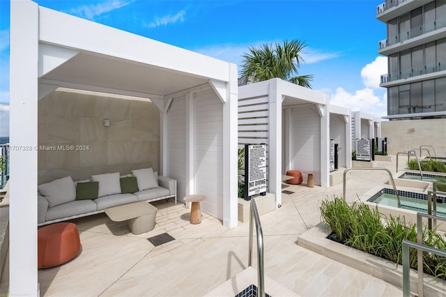 view of patio / terrace with a community hot tub and an outdoor hangout area