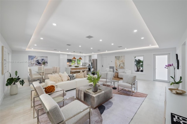 living room featuring a tray ceiling