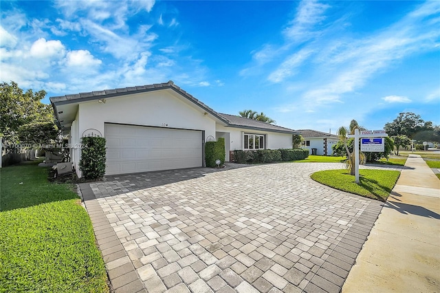 single story home featuring a front yard and a garage