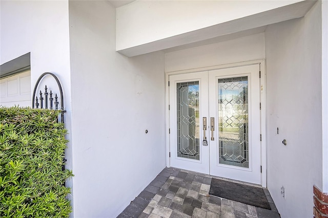 view of exterior entry featuring french doors