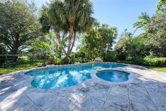 view of swimming pool featuring an in ground hot tub