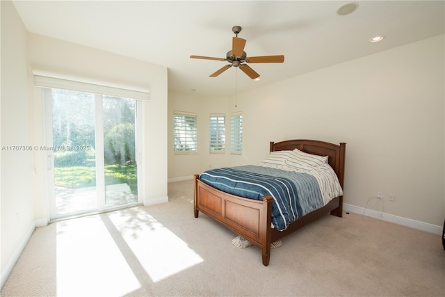 bedroom featuring access to outside, light colored carpet, and ceiling fan