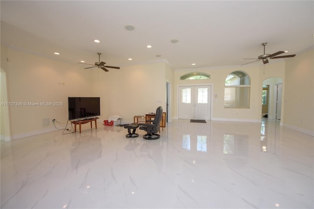 living room with ceiling fan and ornamental molding