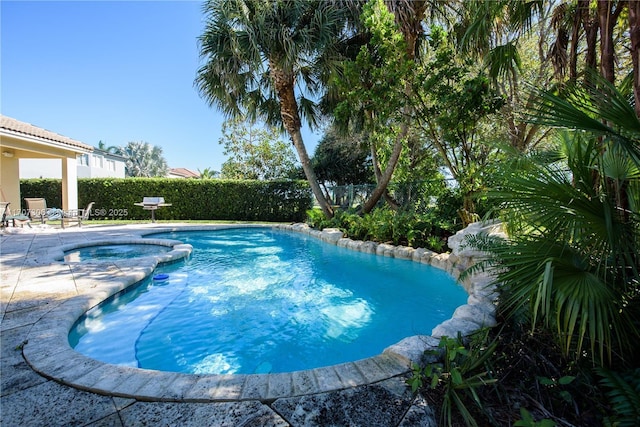 view of pool with an in ground hot tub