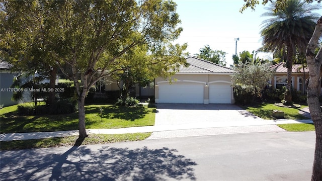 view of front of property featuring a garage and a front yard