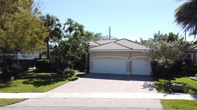 view of front of property with a garage and a front yard