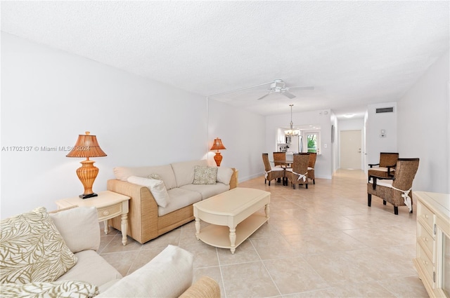 tiled living room with a textured ceiling and ceiling fan