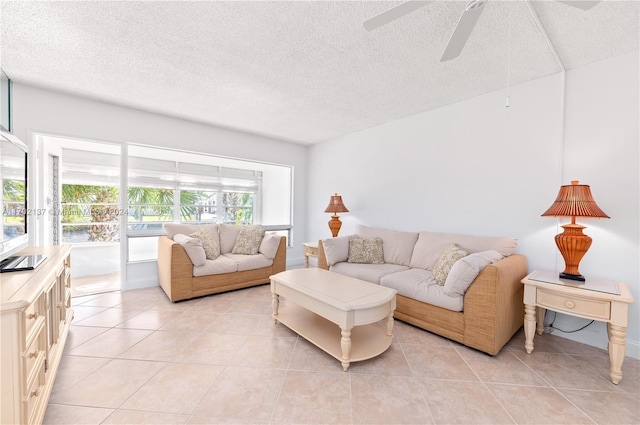 tiled living room with ceiling fan and a textured ceiling