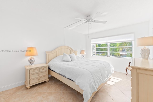 bedroom with ceiling fan and light tile patterned flooring