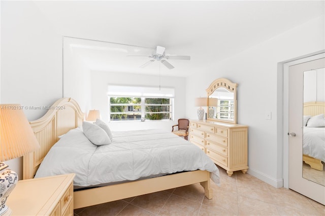 bedroom featuring light tile patterned floors and ceiling fan