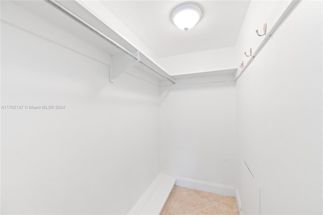 walk in closet featuring light tile patterned flooring