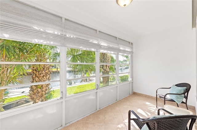 sunroom / solarium featuring a water view