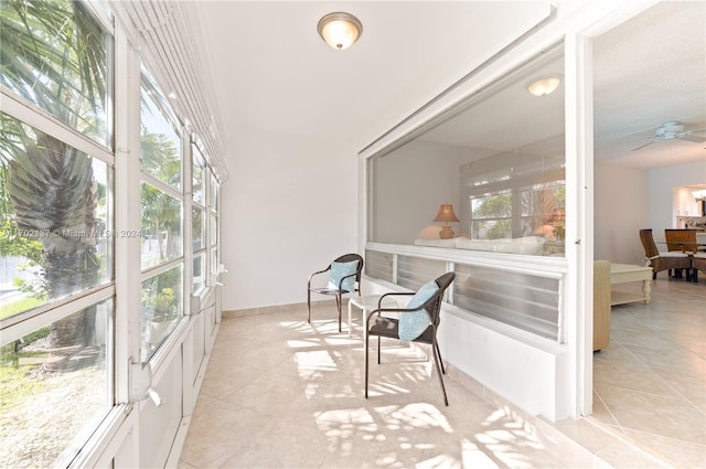 sunroom with ceiling fan and plenty of natural light