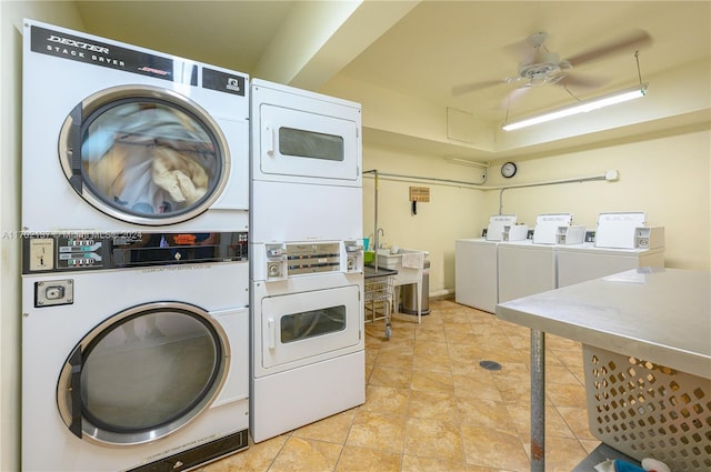 clothes washing area featuring light tile patterned flooring, washer and dryer, ceiling fan, and stacked washing maching and dryer