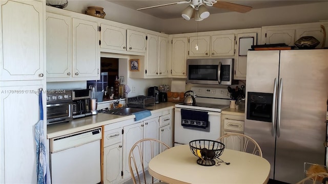 kitchen with ceiling fan, sink, white cabinets, and appliances with stainless steel finishes